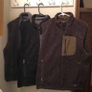 3 Men’s Woolrich vests for sale together.